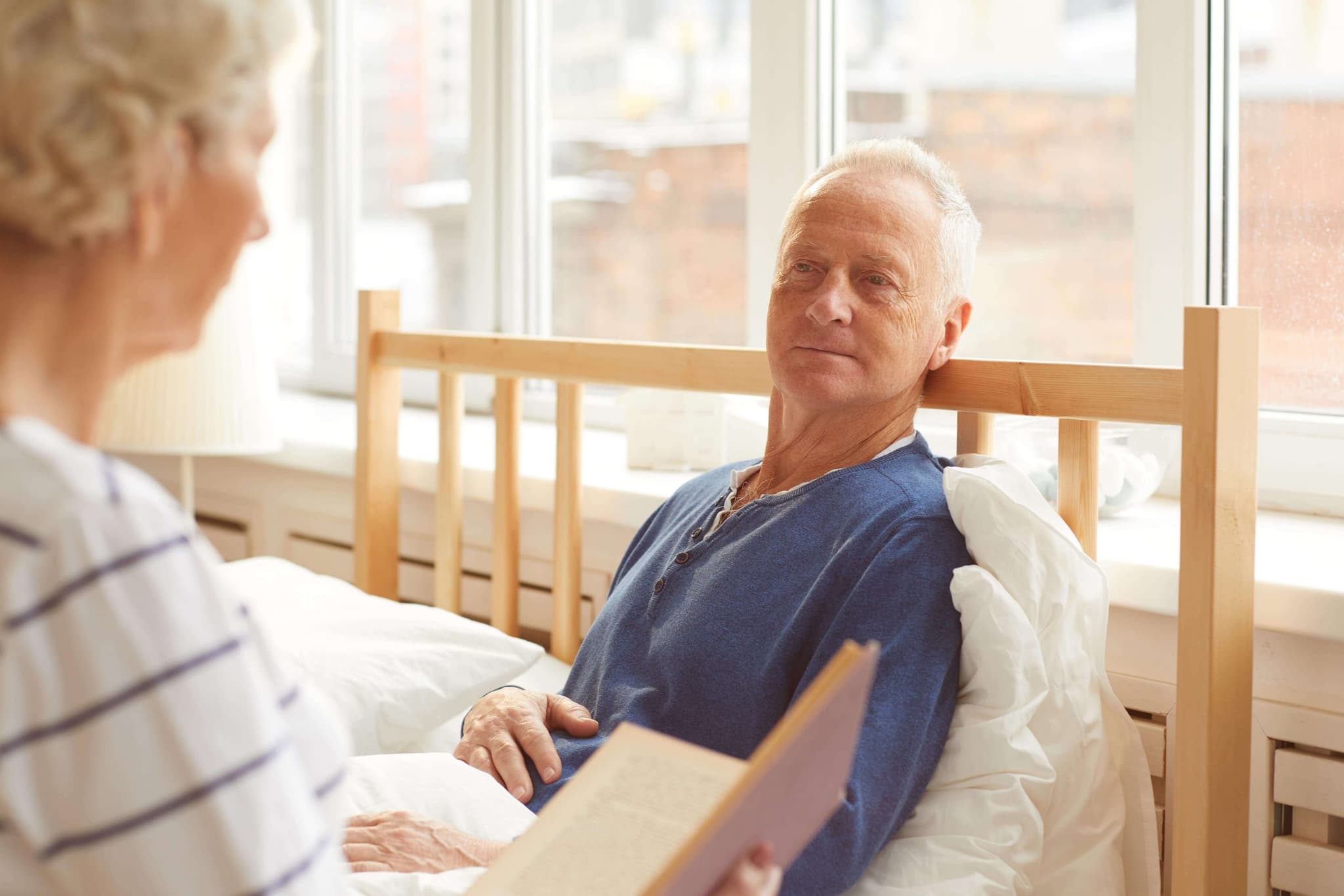 Senior man recovering with assisted care after a hospital stay